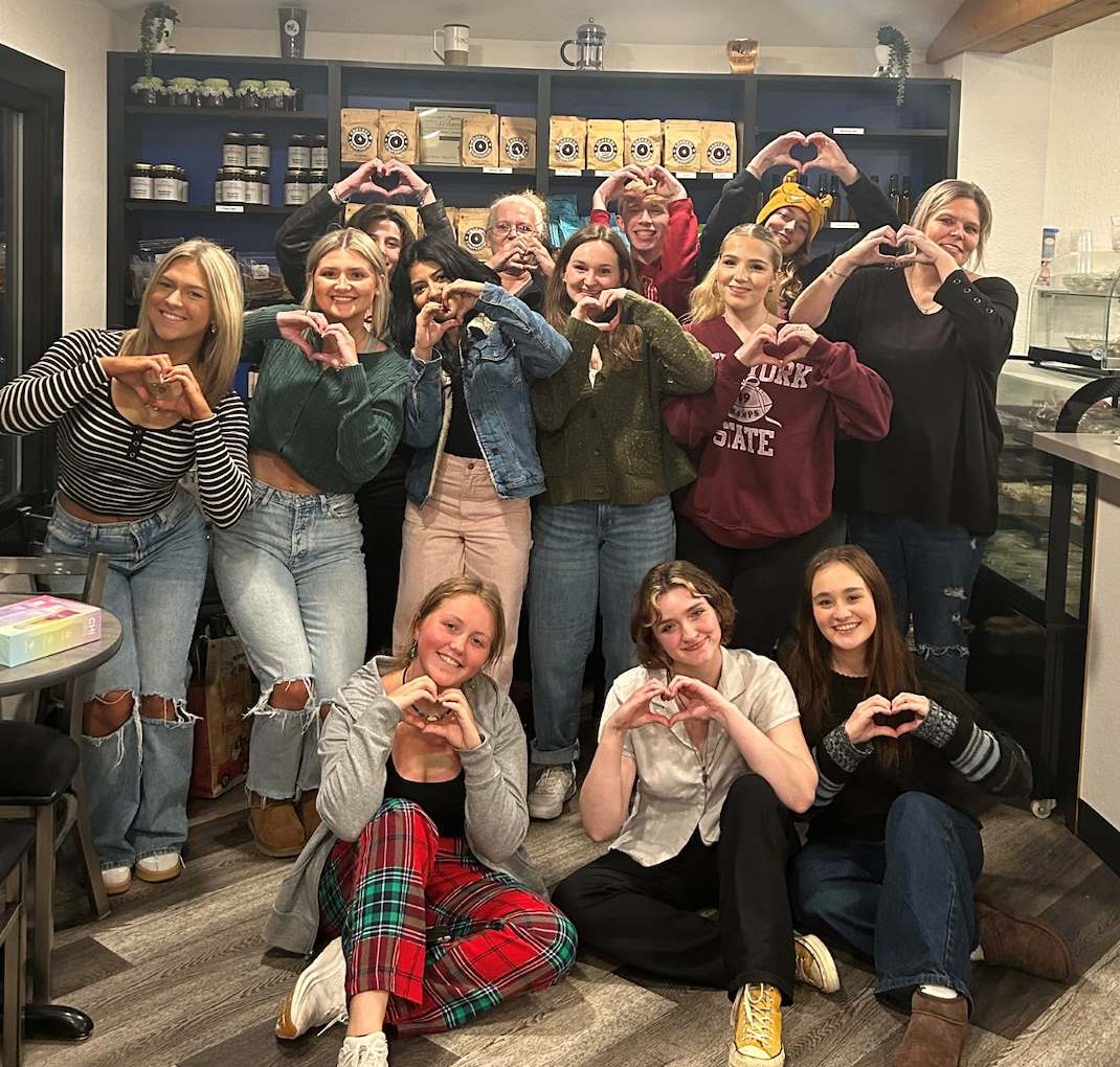KT'z staff making hearts with their hands